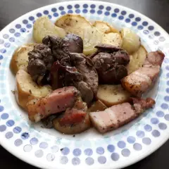 Pyszna watrobka drobiowa z jablkiem z piekarnika, podana z chrupiącym boczkiem i pieczonymi ziemniakami.