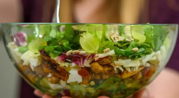 Pyszna sałatka kebab gyros w szklanej misce, pełna świeżych warzyw, kawałków kurczaka i sera. Idealna na lekki posiłek.