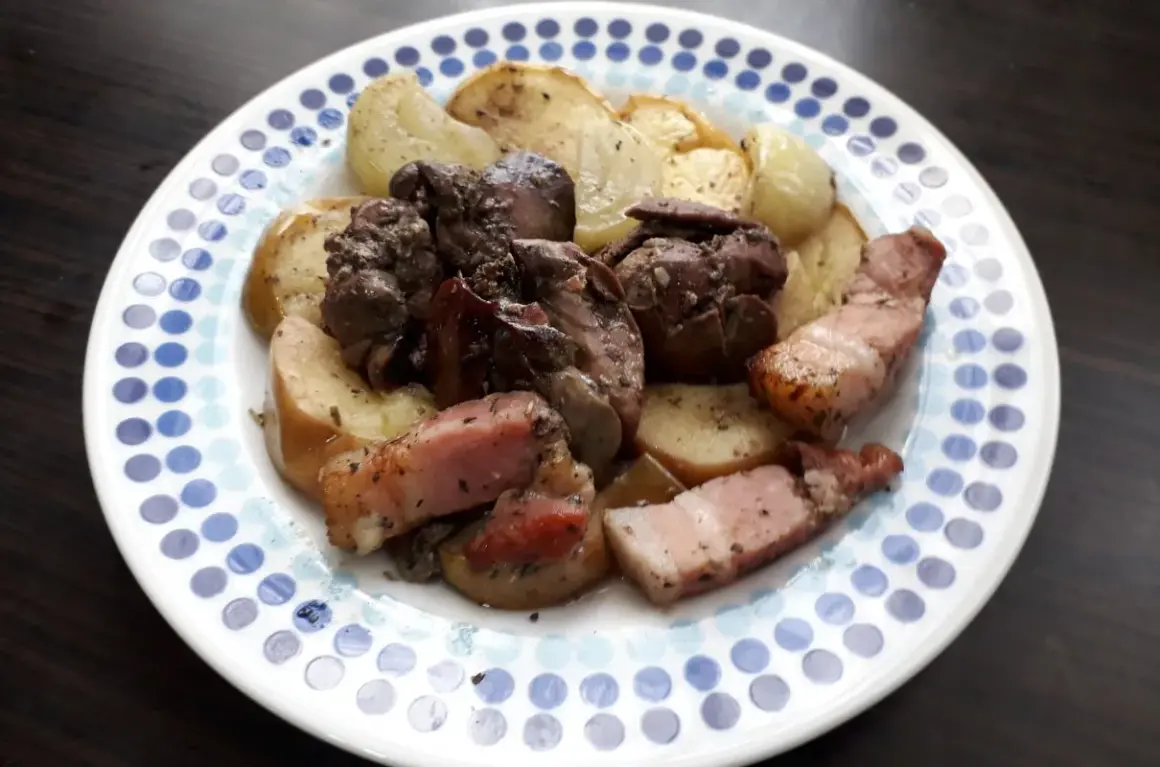 Pyszna watrobka drobiowa z jablkiem z piekarnika, podana z chrupiącym boczkiem i pieczonymi ziemniakami.